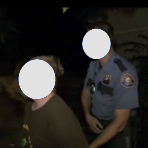 Blurred photo of a police officer and civilian